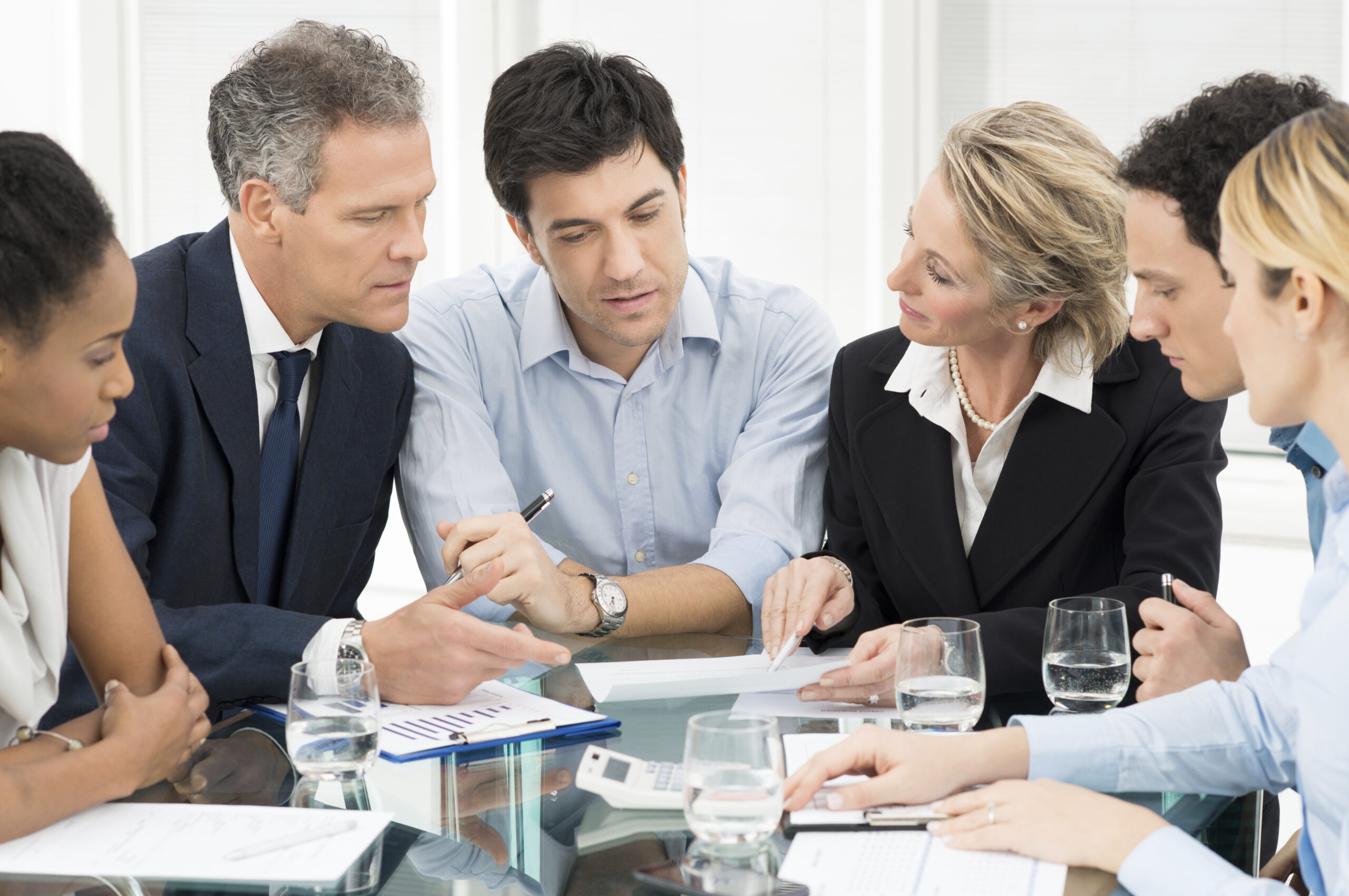 Portrait Of Multiracial Businesspeople Brainstorming In Meeting